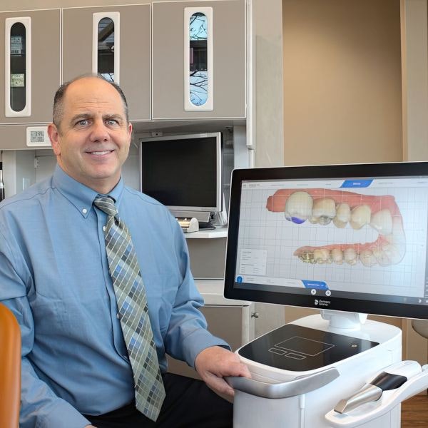 Dr. Slaman sitting next to monitor in his Albuquerque, NM, office