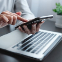 Person typing on phone