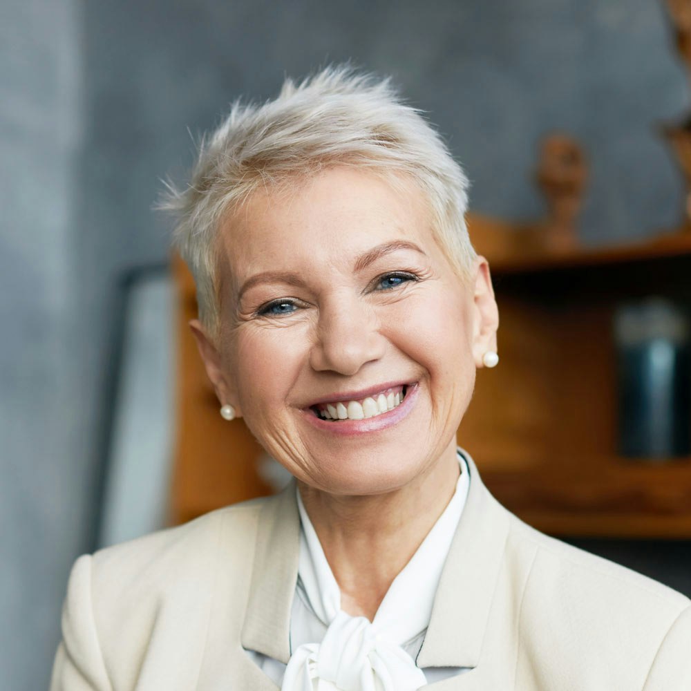 Smiling mature woman after restorative dentistry treatments